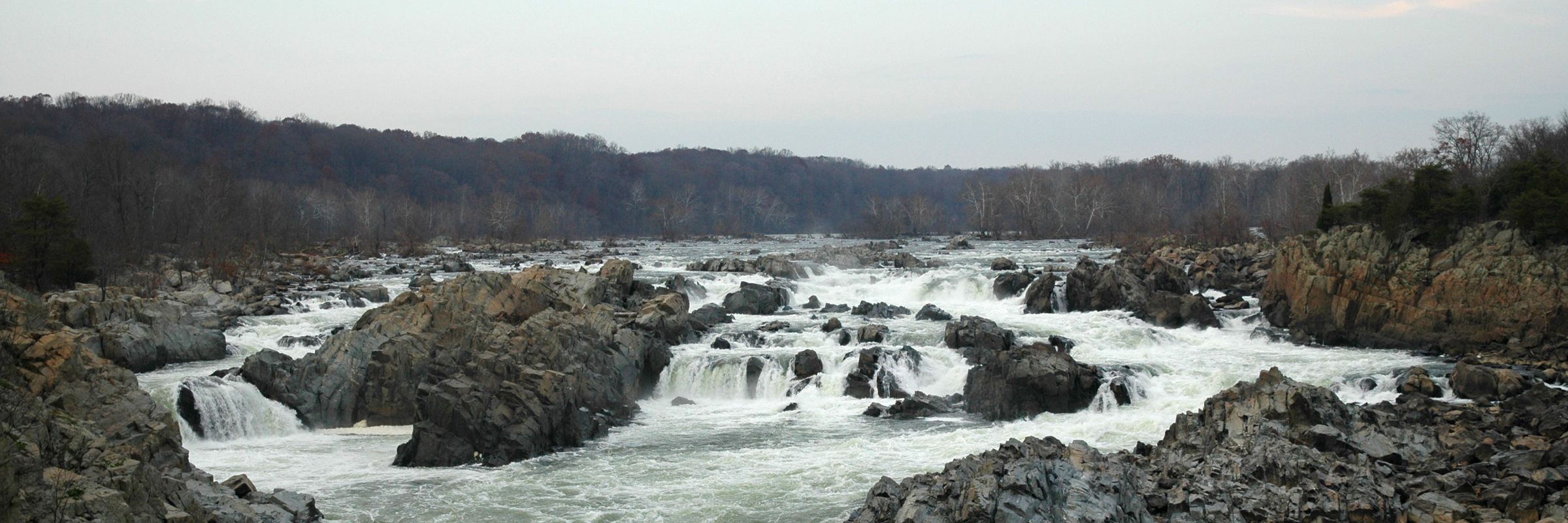 Great Falls of the Potomac River, with white water rushing between dark rocks.